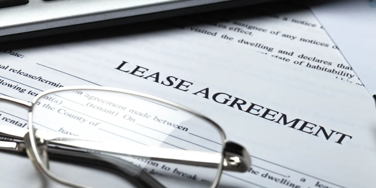 Commercial real estate advisor reviewing lease documents with client